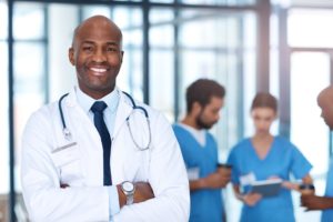 emergency medicine physician standing with staff
