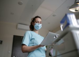 Nurse In Blue Scrubs and Blue Surgical Mask